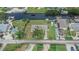 An aerial view shows a canal-front home with lush landscaping and a long driveway at 814 Seabreeze Dr, Ruskin, FL 33570
