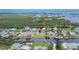An aerial shot showcases the property and neighborhood within proximity to waterfront canal at 814 Seabreeze Dr, Ruskin, FL 33570