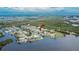 An aerial view of a home with canal access, lush greenery and waterfront views at 814 Seabreeze Dr, Ruskin, FL 33570