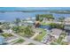 Aerial view of waterfront home with dock, lush landscaping, and stunning bay views at 814 Seabreeze Dr, Ruskin, FL 33570