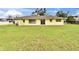 Wide backyard with generous lawn space and sliders to the home's interior at 814 Seabreeze Dr, Ruskin, FL 33570