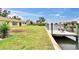 Backyard view featuring new deck on the water, and lush green lawn at 814 Seabreeze Dr, Ruskin, FL 33570