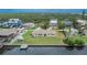 Aerial view shows backyard and waterfront access including adjacent waterfront neighborhood homes at 814 Seabreeze Dr, Ruskin, FL 33570