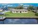 Aerial view shows backyard, waterside access, and waterfront neighborhood homes across canal at 814 Seabreeze Dr, Ruskin, FL 33570
