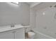 Bright bathroom featuring a bathtub with shower, toilet and vanity with sink at 814 Seabreeze Dr, Ruskin, FL 33570