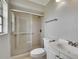 Bathroom featuring glass enclosed shower, toilet, and sink vanity at 814 Seabreeze Dr, Ruskin, FL 33570