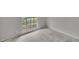 The bedroom has light gray walls and a window to let in natural light at 814 Seabreeze Dr, Ruskin, FL 33570