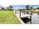 Dock with new white decking and bench seating on waterfront property at 814 Seabreeze Dr, Ruskin, FL 33570