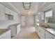 Kitchen with white cabinets, granite countertops, stainless sink, and natural light at 814 Seabreeze Dr, Ruskin, FL 33570