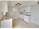 Kitchen with white cabinetry, granite countertops, stainless sink, and tile flooring at 814 Seabreeze Dr, Ruskin, FL 33570