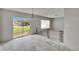 Bright living room features light gray walls, a chandelier, and sliding glass doors to the backyard at 814 Seabreeze Dr, Ruskin, FL 33570