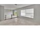 Bright living room features light gray walls, a chandelier, sliding glass doors to the backyard, and a window at 814 Seabreeze Dr, Ruskin, FL 33570