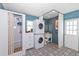 Unique bathroom featuring a stacked washer and dryer, vibrant blue walls, and a stylish patterned floor at 8347 41St N Ave, St Petersburg, FL 33709