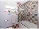 Bathroom featuring a shower-tub combination with tiled walls, decorative accents, and well-lit ambiance at 8347 41St N Ave, St Petersburg, FL 33709