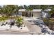 Inviting single-story home featuring well-maintained landscaping, a light grey exterior, and a spacious driveway at 8347 41St N Ave, St Petersburg, FL 33709