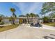 Attractive single-story home with a well-kept lawn and driveway, accented by lush landscaping and a yellow front door at 8347 41St N Ave, St Petersburg, FL 33709
