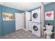 Updated laundry room features unique tile flooring, stacked washer/dryer, and a stand-up shower at 8347 41St N Ave, St Petersburg, FL 33709
