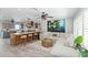 Open-concept living space with modern kitchen, island seating, and inviting living room area with statement art at 8347 41St N Ave, St Petersburg, FL 33709