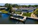 Stunning aerial view of a waterfront home featuring lush landscaping, outdoor entertaining spaces, and a private boat dock at 9301 Sun Isle Ne Dr, St Petersburg, FL 33702