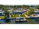 Aerial view of canal home with dock and boat lift, surrounded by lush landscaping at 9301 Sun Isle Ne Dr, St Petersburg, FL 33702