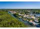 Aerial view of waterfront home with dock, lush landscaping, and serene canal setting at 9301 Sun Isle Ne Dr, St Petersburg, FL 33702