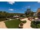 Serene backyard with a fire pit, chairs, lush lawn, and boat dock access offering peaceful waterfront living at 9301 Sun Isle Ne Dr, St Petersburg, FL 33702