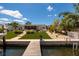 Lovely backyard featuring manicured lawn, patio with seating, and waterfront access, perfect for outdoor enjoyment at 9301 Sun Isle Ne Dr, St Petersburg, FL 33702