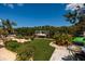 Backyard patio with waterfront dock and boat lift, surrounded by greenery at 9301 Sun Isle Ne Dr, St Petersburg, FL 33702