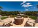 Inviting backyard oasis with a fire pit, chairs, and a boat lift offering stunning views of the water at 9301 Sun Isle Ne Dr, St Petersburg, FL 33702