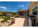 Spacious backyard featuring a grill, an outdoor sink, chairs, and access to serene waterfront views at 9301 Sun Isle Ne Dr, St Petersburg, FL 33702