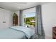 Bright bedroom featuring access to outdoor patio and views of the canal at 9301 Sun Isle Ne Dr, St Petersburg, FL 33702