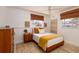 Well-lit bedroom with woven blinds, side table, and decor for a cozy, comfortable feel at 9301 Sun Isle Ne Dr, St Petersburg, FL 33702