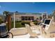 Boat with a lift overlooking the landscaped lawn, patio, and waterfront property at 9301 Sun Isle Ne Dr, St Petersburg, FL 33702