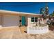Charming single-Gathering home with a one car garage and inviting turquoise door at 9301 Sun Isle Ne Dr, St Petersburg, FL 33702