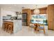 Bright, open kitchen featuring stone countertops, stainless steel appliances, and dining nook at 9301 Sun Isle Ne Dr, St Petersburg, FL 33702