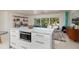 Modern kitchen with white island and open access to the living room at 9301 Sun Isle Ne Dr, St Petersburg, FL 33702