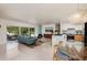 Open-concept living area with modern accents, marble island, and serene outdoor views at 9301 Sun Isle Ne Dr, St Petersburg, FL 33702