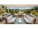 Relaxing sunroom featuring comfortable seating and a picturesque waterfront view, ideal for enjoying the serene scenery at 9301 Sun Isle Ne Dr, St Petersburg, FL 33702