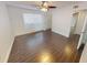 A well-lit room with a ceiling fan, a window with blinds, and beautiful dark-toned tile flooring at 9481 Highland Oak Dr # 1003, Tampa, FL 33647