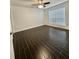 A well-lit room with a ceiling fan, a window with blinds, and beautiful dark-toned tile flooring at 9481 Highland Oak Dr # 1003, Tampa, FL 33647