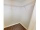 A well-lit closet with dark-toned floors and a metal shelf at 9481 Highland Oak Dr # 1003, Tampa, FL 33647