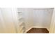 A well-lit closet with dark-toned floors and shelving for ample storage space at 9481 Highland Oak Dr # 1003, Tampa, FL 33647