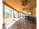 Outdoor covered patio featuring chairs, ceiling fans, tile floors, and a view of the community at 9481 Highland Oak Dr # 1003, Tampa, FL 33647