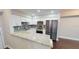 Kitchen featuring white cabinets, stainless steel appliances, granite countertops, and tile backsplash at 9481 Highland Oak Dr # 1003, Tampa, FL 33647