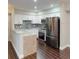 Bright kitchen with white cabinets, stainless steel appliances, tile backsplash, and granite countertops at 9481 Highland Oak Dr # 1003, Tampa, FL 33647