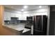 Kitchen featuring white cabinets, stainless steel appliances, granite countertops, and tile backsplash at 9481 Highland Oak Dr # 1003, Tampa, FL 33647