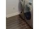 The laundry room is equipped with a modern washer and dryer, plus stylish tile flooring at 9481 Highland Oak Dr # 1003, Tampa, FL 33647