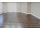Living area showcasing wood look flooring, lots of natural light, and neutral walls at 9481 Highland Oak Dr # 1003, Tampa, FL 33647