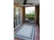 Outdoor patio with neutral-colored brick flooring, a ceiling fan, and a view of the natural outdoor landscape at 9481 Highland Oak Dr # 1003, Tampa, FL 33647