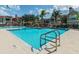 Community pool with clear blue water and surrounding lounge chairs for relaxation under the sun at 9481 Highland Oak Dr # 1003, Tampa, FL 33647